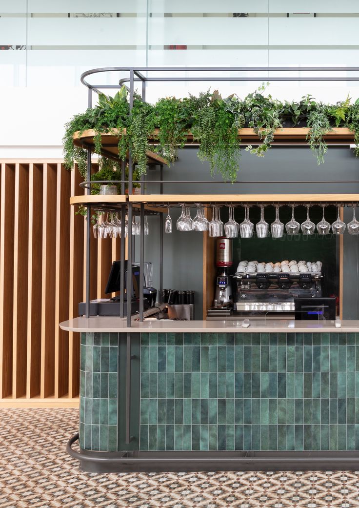 an outdoor bar with plants and wine glasses hanging from the roof, along with tile flooring