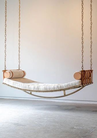 a hanging bed with two pillows on the bottom and one mattress in the middle that is attached to chains