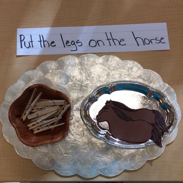 there is a plate with a horse on it and some sticks in the shape of a bowl