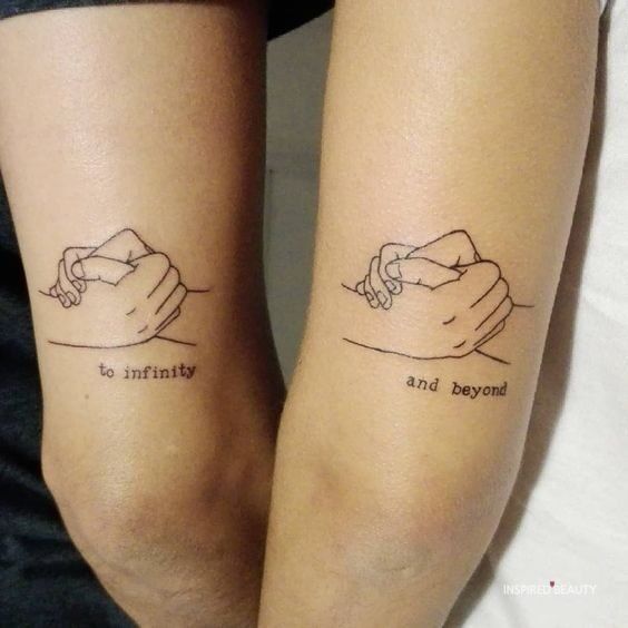 two people holding hands with words tattooed on their arms that read, beyond and beyond