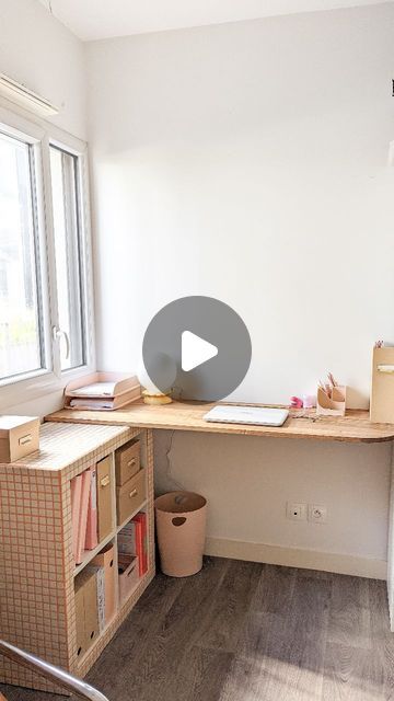 a room with a desk, bookshelf and window