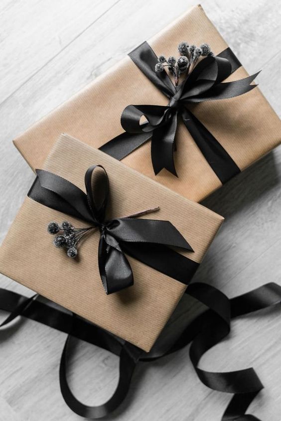 two wrapped presents with black ribbons and bows