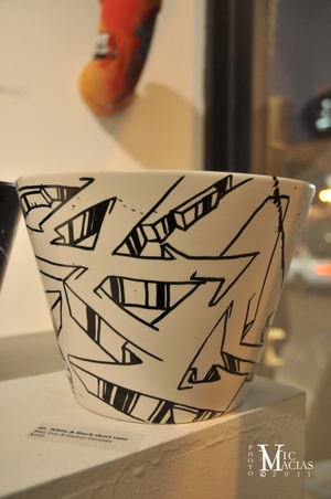 a black and white cup sitting on top of a counter