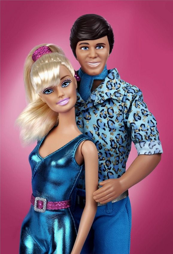 barbie and ken doll posed together in front of a pink background