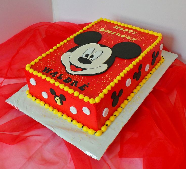 a red and white cake with mickey mouse on it