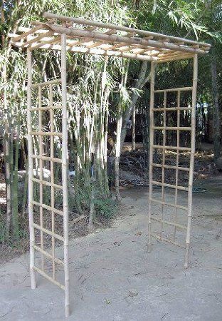 an outdoor bamboo arbor in front of some trees