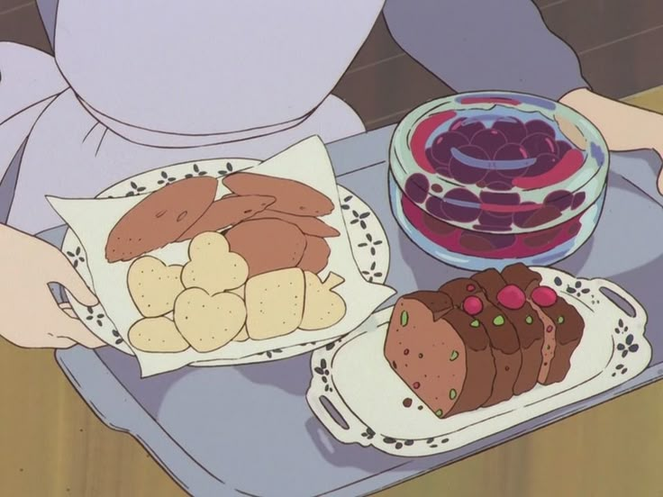 a person sitting at a table with plates of food in front of them and a bowl of fruit on the plate