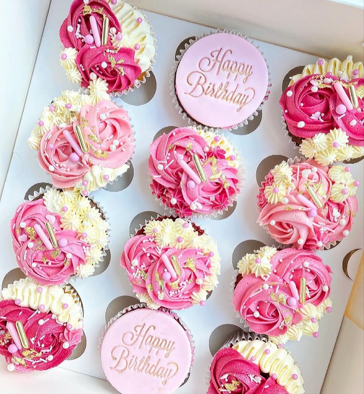 pink and white cupcakes in a box with happy birthday written on the top