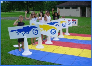 children are standing in front of several signs on the ground with numbers painted on them