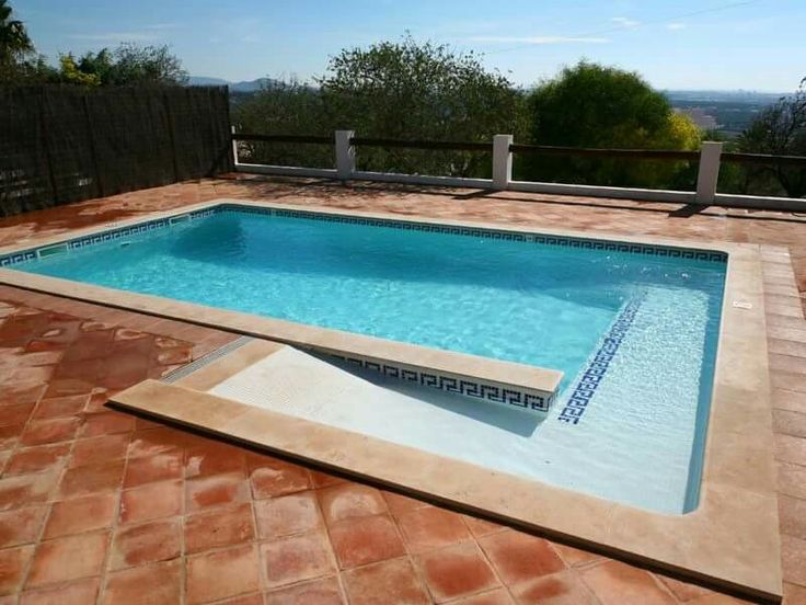 an above ground swimming pool with tiled flooring