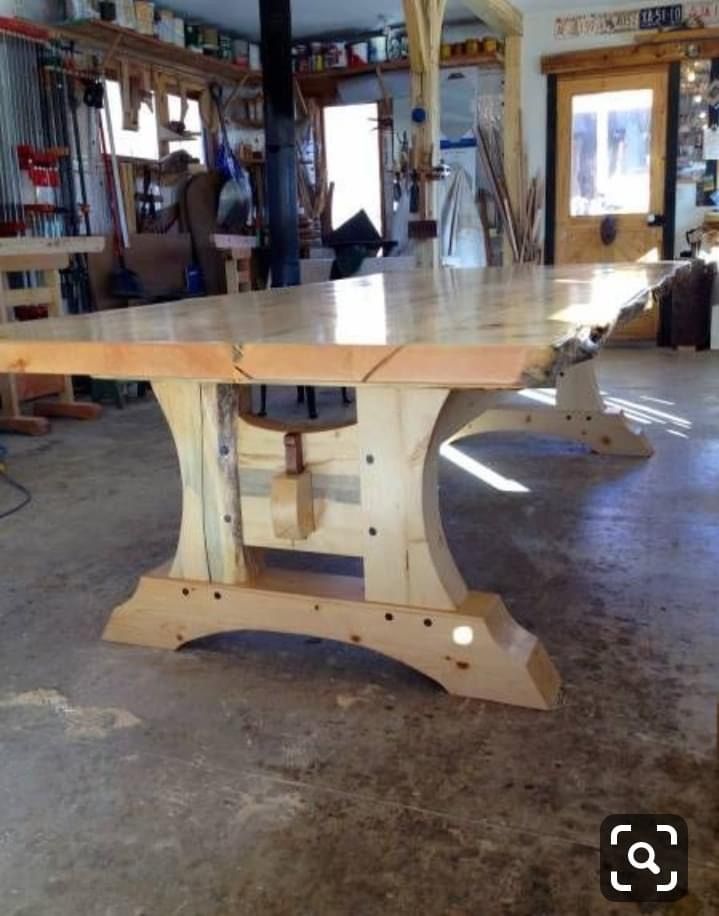 a large wooden table sitting inside of a building