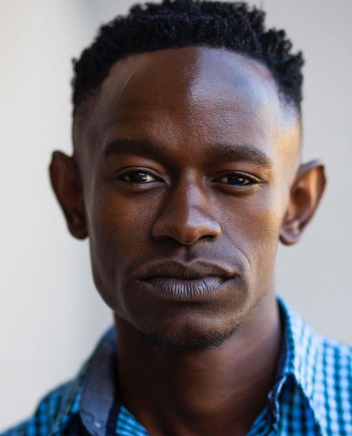 a close up of a person wearing a blue and white checkered shirt with black hair