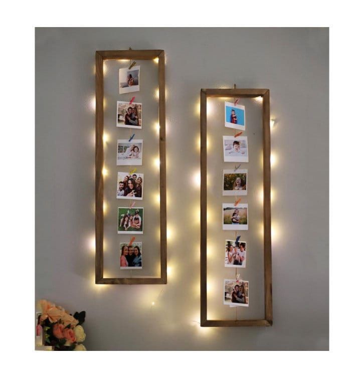 two wooden frames with lights hanging on the wall