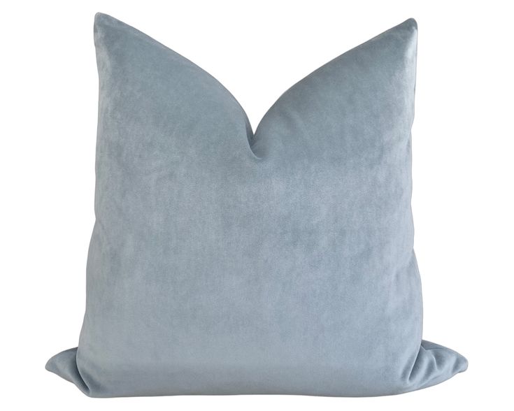 a light blue pillow on a white background