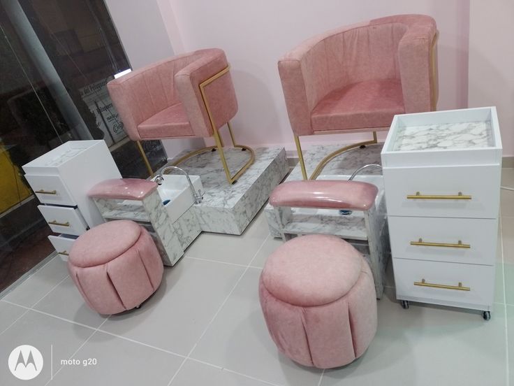 pink chairs and foot stools in a room with marble floor tiles on the floor