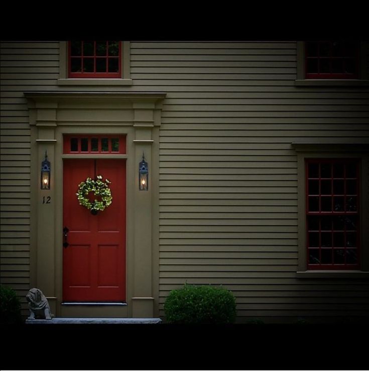 a red front door with a wreath on it