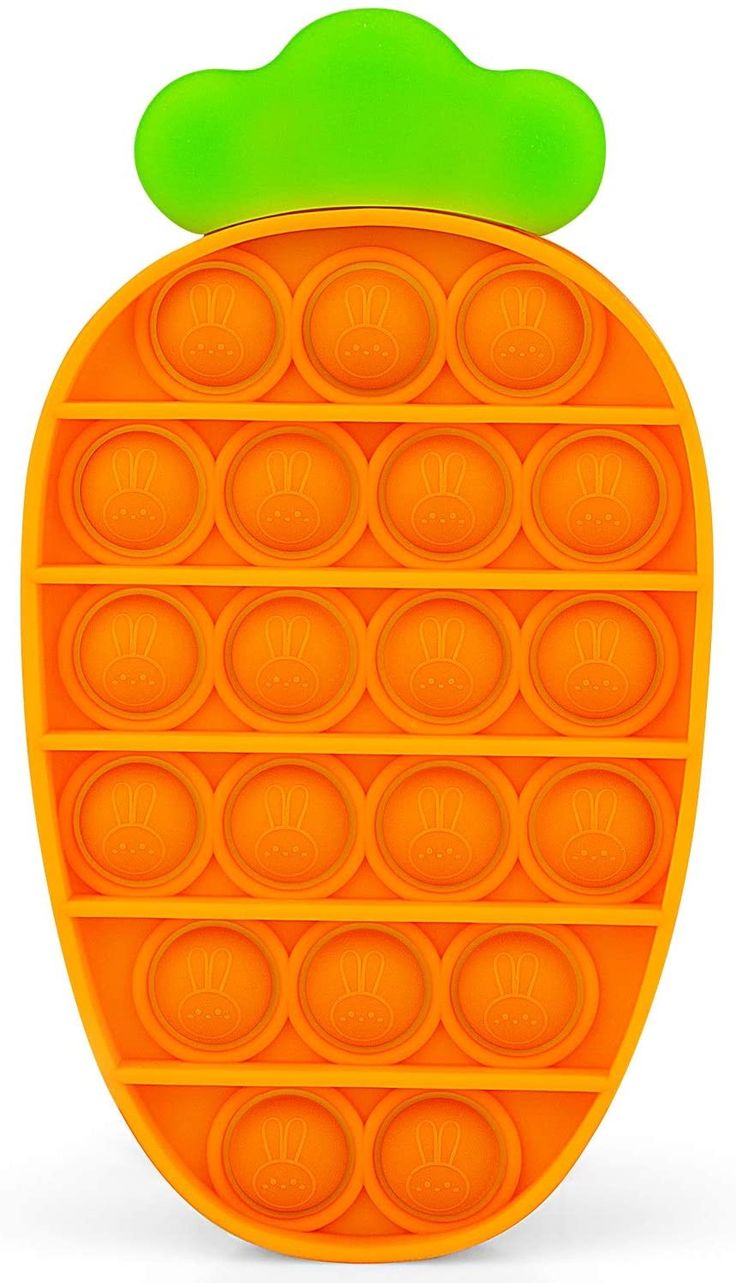 an orange and green toy shaped like a pineapple with circles on the bottom, in front of a white background