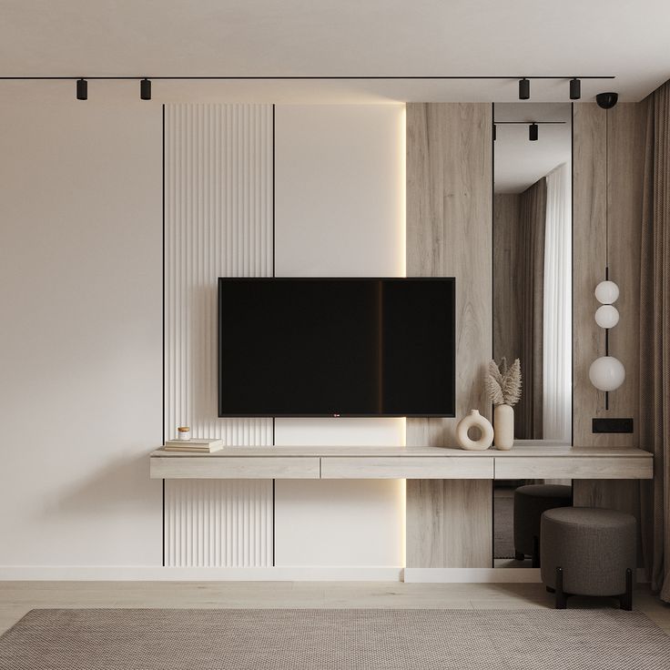 a flat screen tv sitting on top of a white shelf in a living room next to a mirror