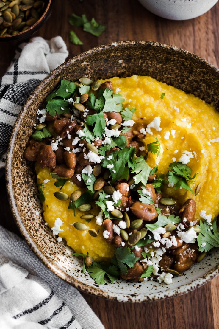 a bowl filled with mashed potatoes and garnished with cilantro