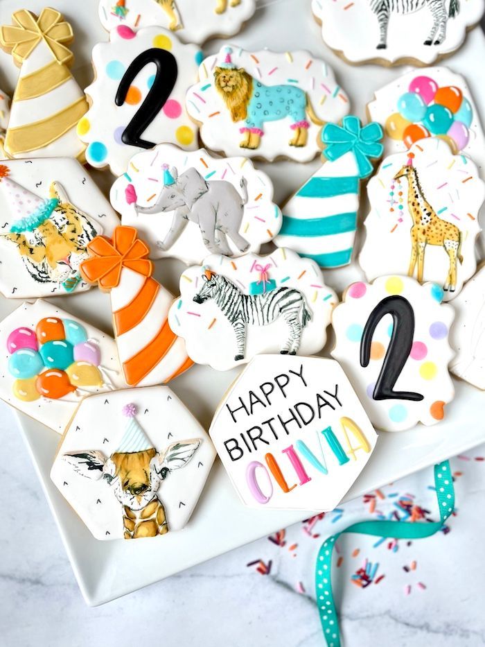 birthday cookies are arranged on a white plate