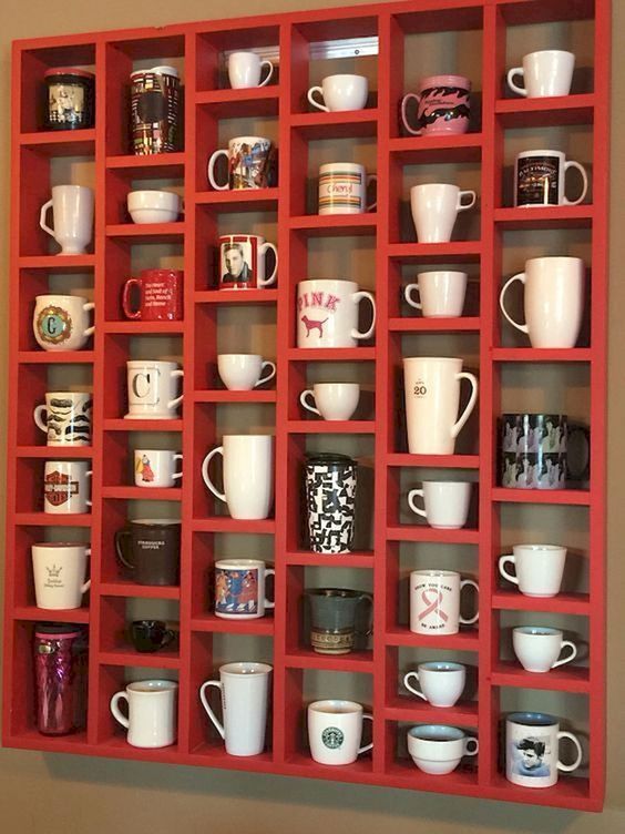 a red shelf filled with lots of coffee cups