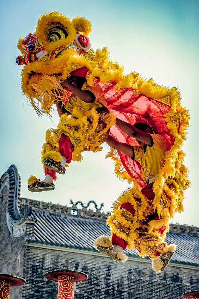 a person in yellow and red costume doing a trick