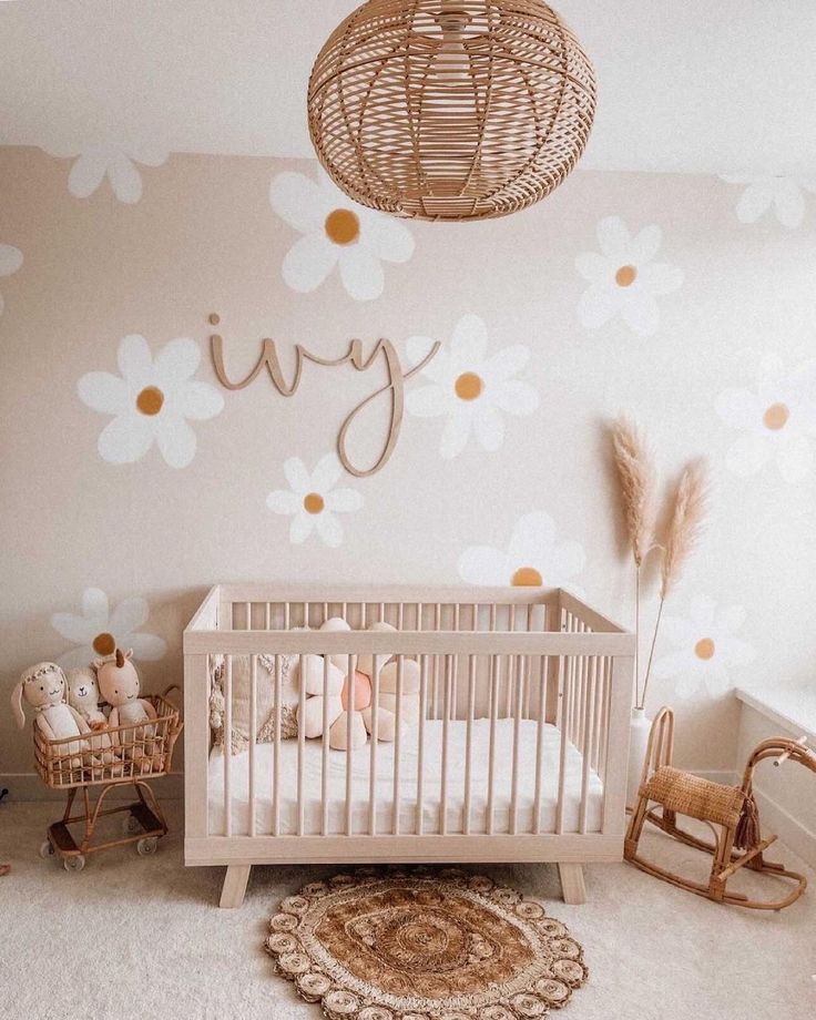 a baby's room with a crib, rocking chair and flower wallpaper