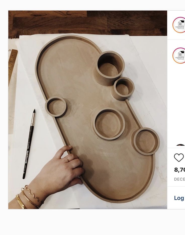 a person is making an art project out of clay