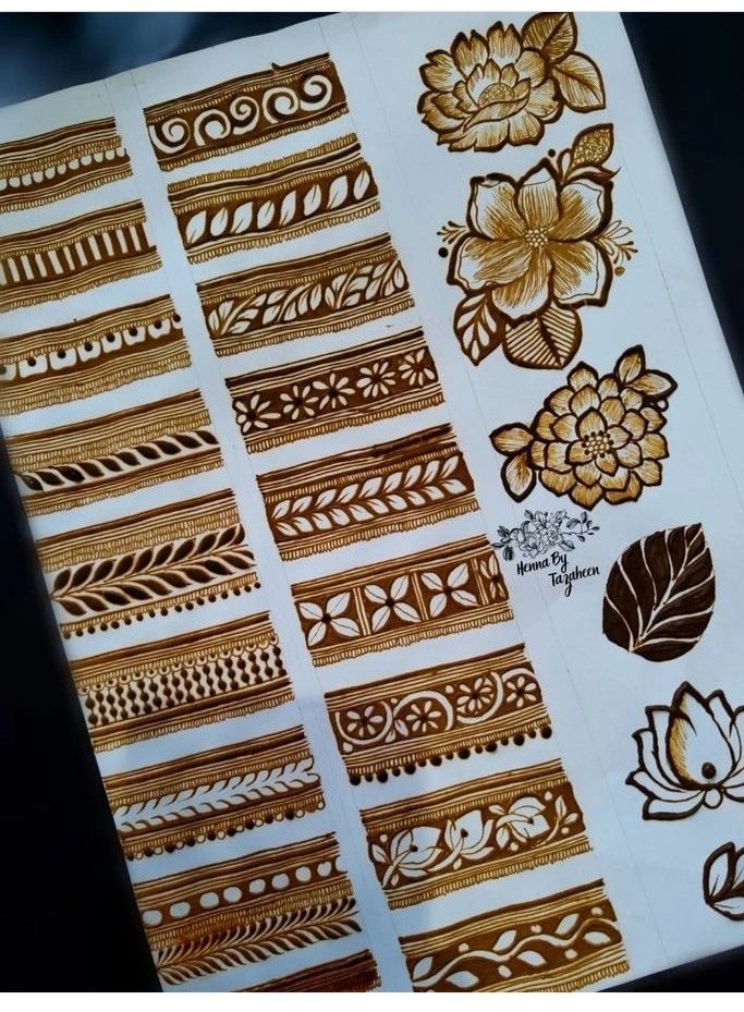 some brown and white designs on a piece of paper with gold foiling in the middle