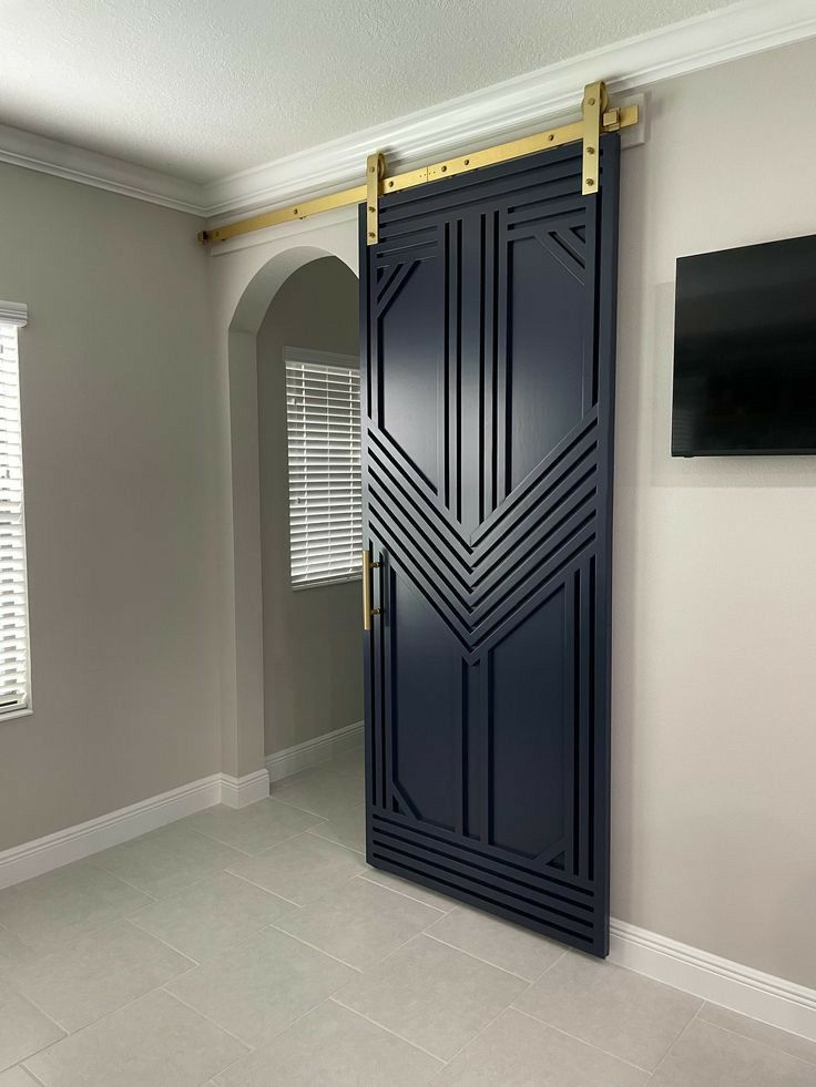 an open door in the middle of a room with white walls and tile flooring