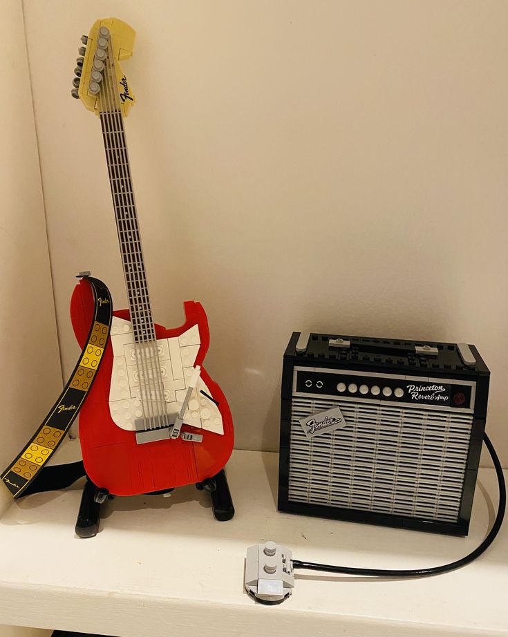 an electric guitar and amp sit on a shelf