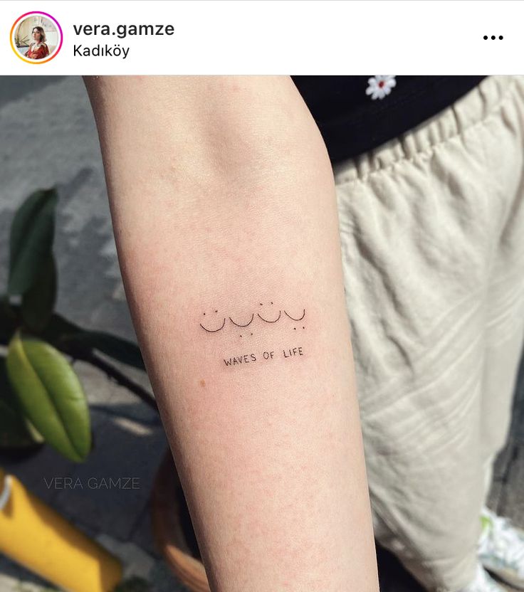 a person with a tattoo on their arm that says, women of life written in cursive writing