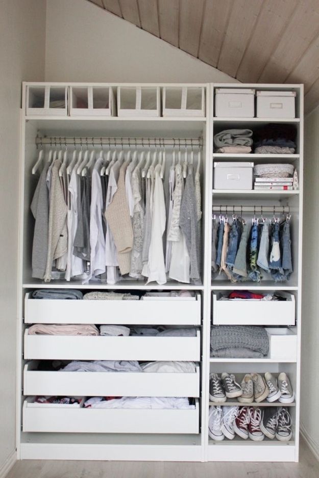 a white closet filled with lots of clothes