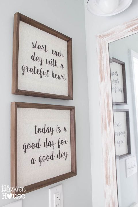 two framed pictures on the wall above a mirror