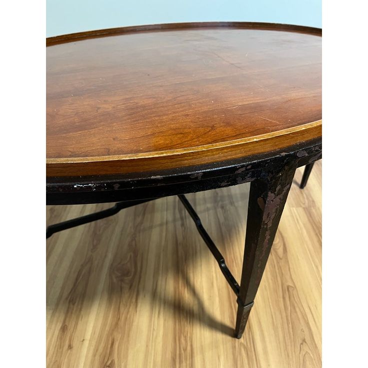 an oval wooden table sitting on top of a hard wood floor