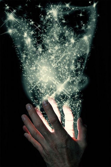 a person holding their hand out to touch the stars