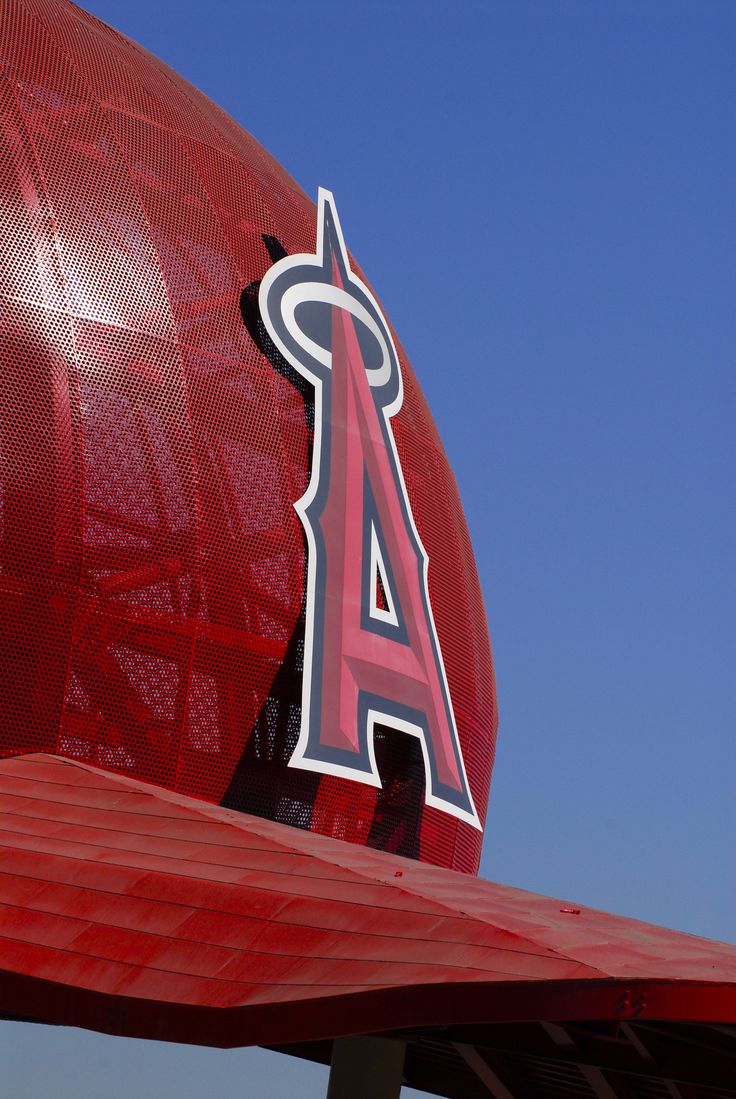 the los angeles angels logo is on top of a large red structure with a blue sky in the background