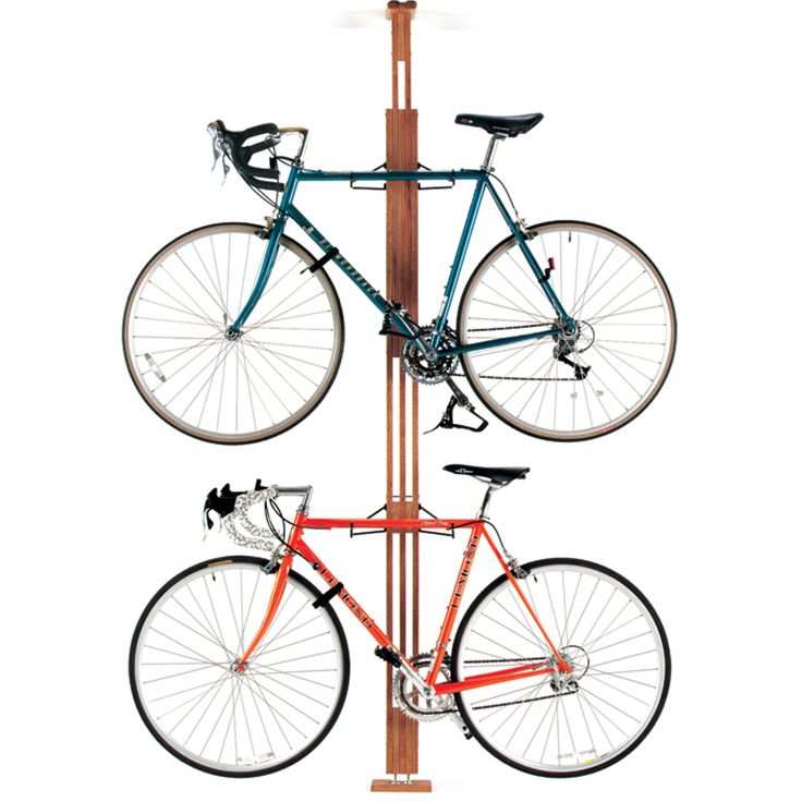 a bicycle is mounted to a pole with two bicycles on it's back end