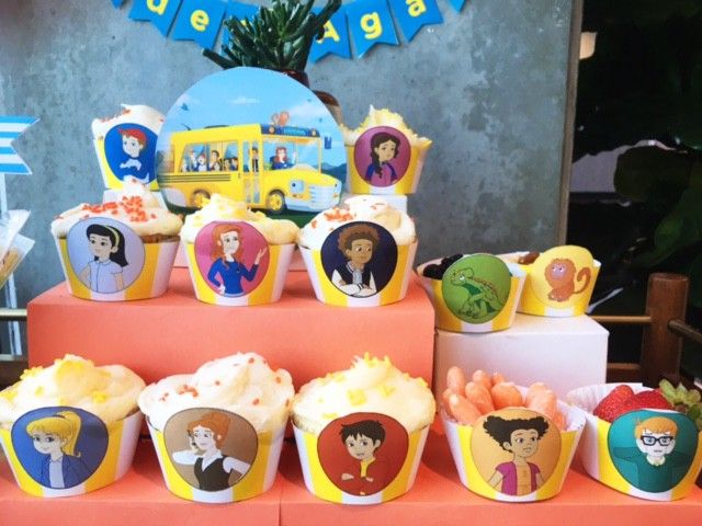 there are many cupcakes on the table with different characters and decorations around them