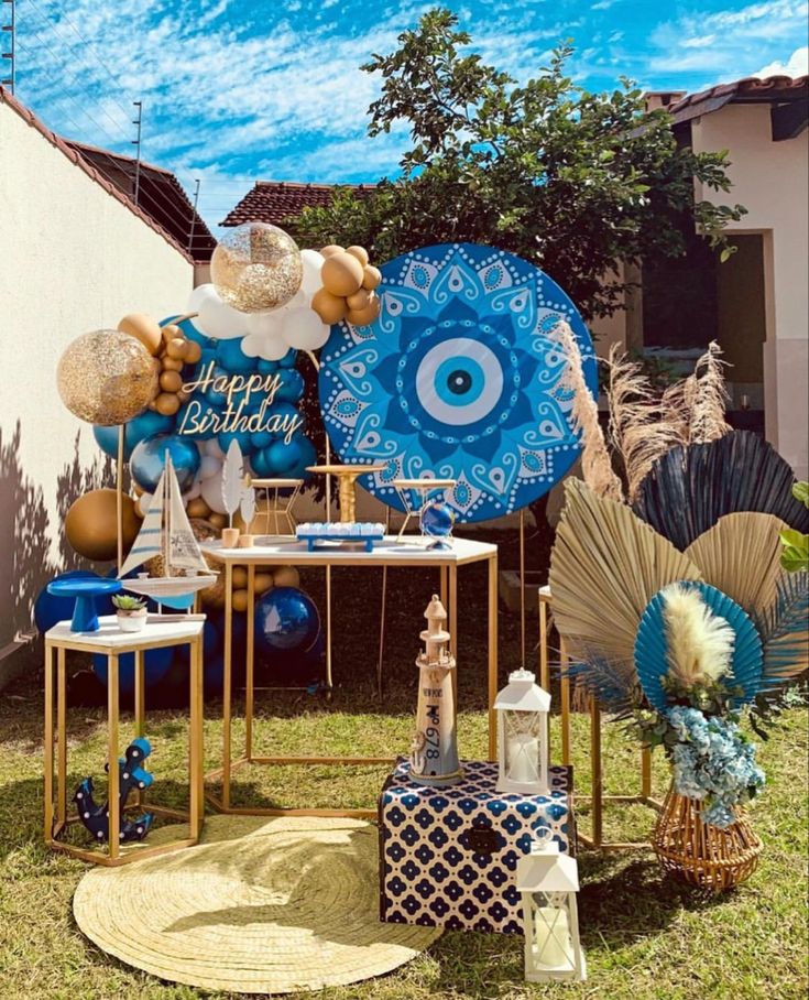 an outdoor birthday party with blue and gold decorations