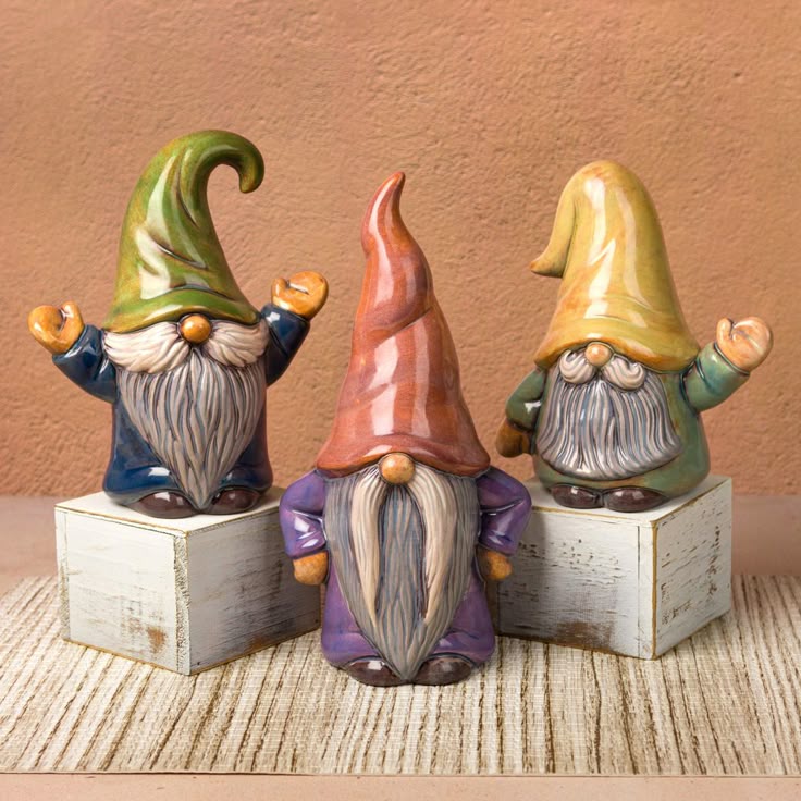 three gnome figurines sitting on top of each other