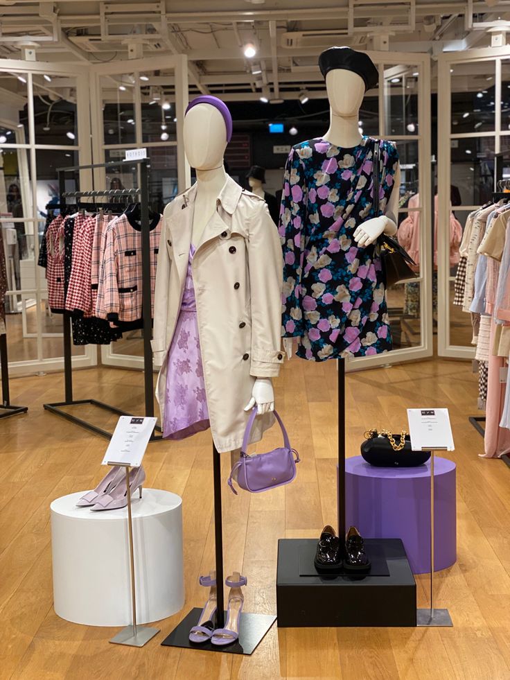 two mannequins dressed in clothes and shoes on display at a clothing store