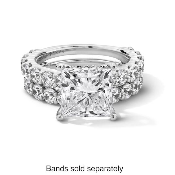 a princess cut diamond engagement ring with three side stones on the band and two rows of diamonds