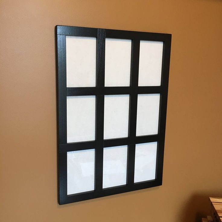 a black and white window on the side of a wall