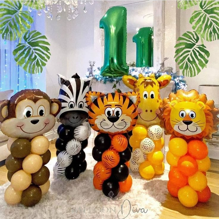 some very cute looking balloons in the shape of lions and zebras with numbers 1 on them