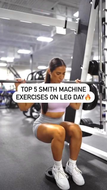 a woman squats on the ground while holding a barbell in front of her