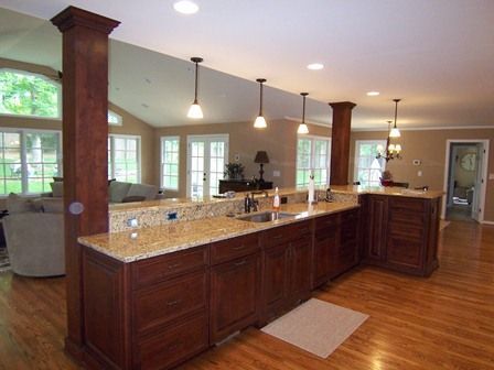 a large kitchen with wooden floors and granite counter tops