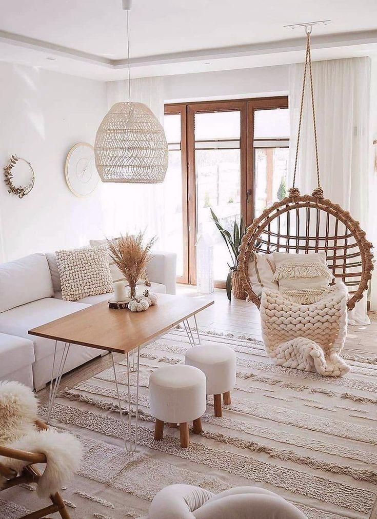 a living room filled with lots of white furniture and decor on top of a rug