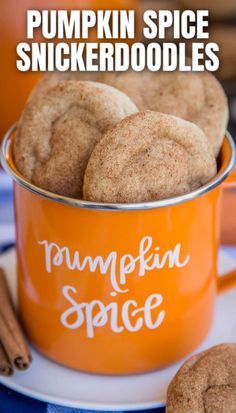 pumpkin spice snickkerdoodles in an orange cup with cinnamon sticks on the side