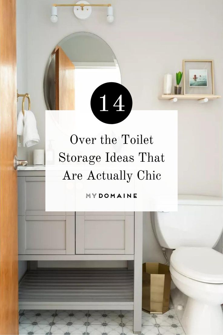 a white toilet sitting under a bathroom mirror next to a wooden shelf filled with items